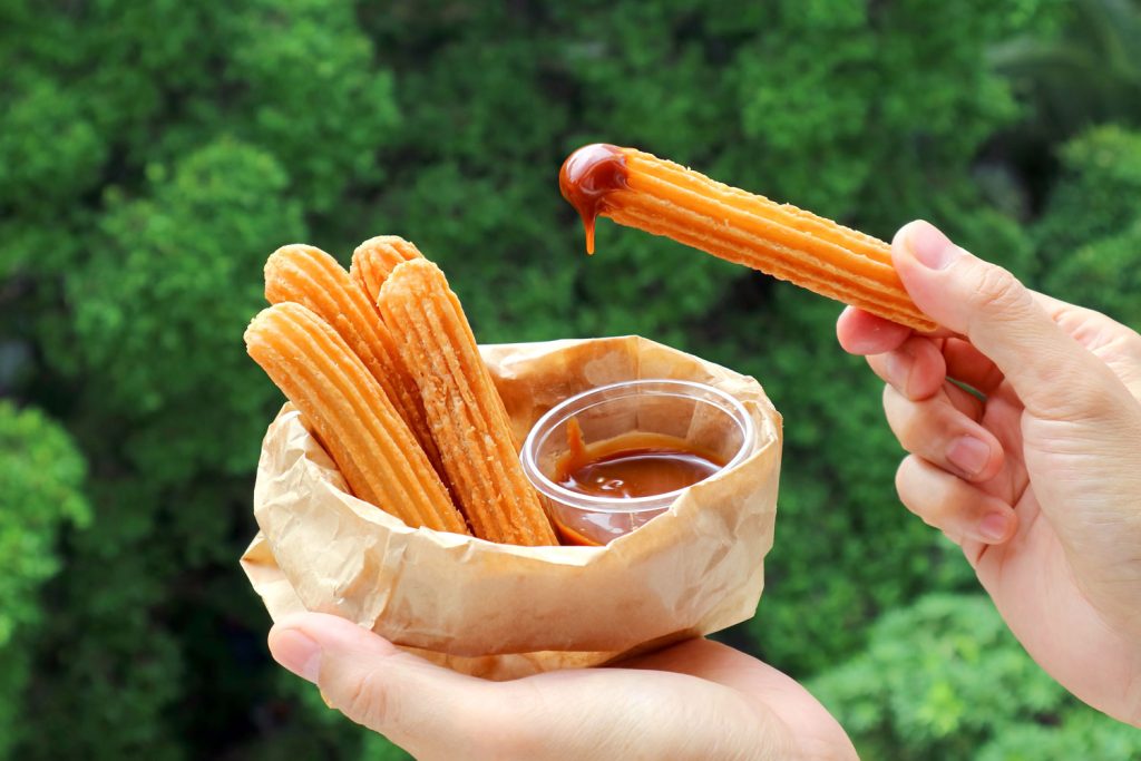 Churros dipping in sauce