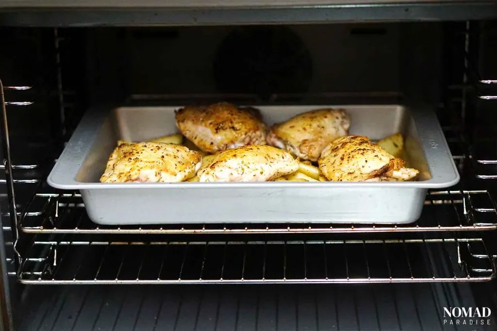 Chicken vesuvio step-by-step (placing the baking tray in the oven)