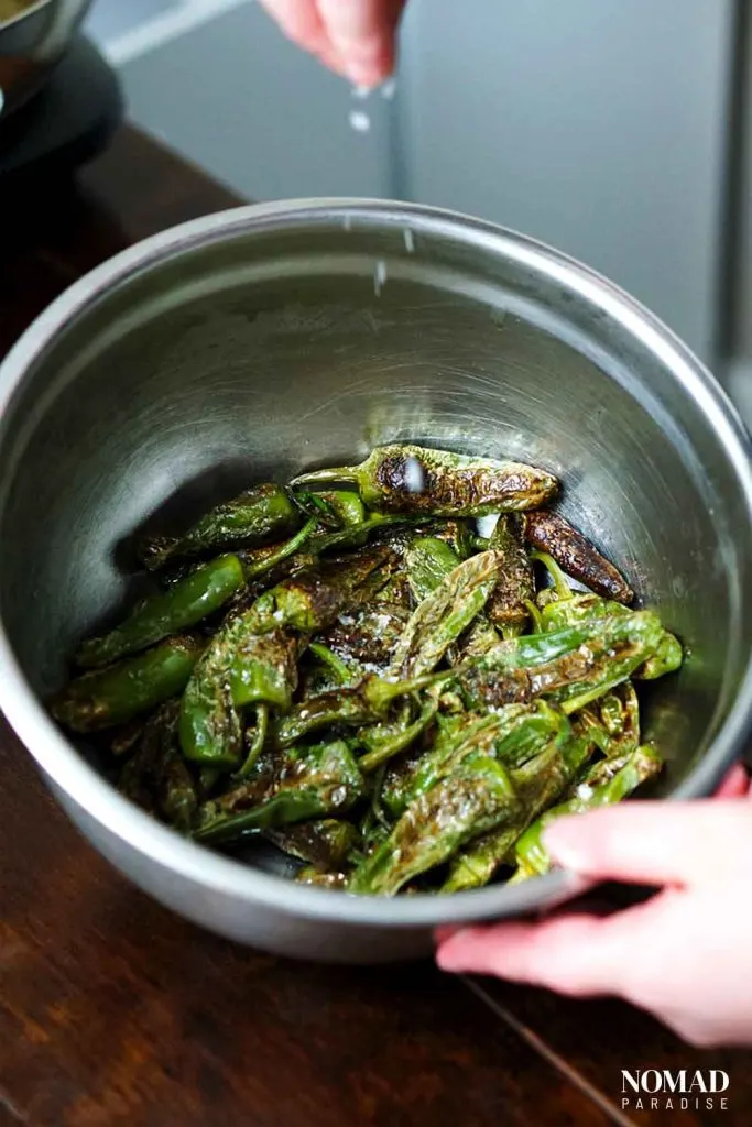 Spanish Padron Peppers Step-by-Step (tossing the charred peppers with salt).