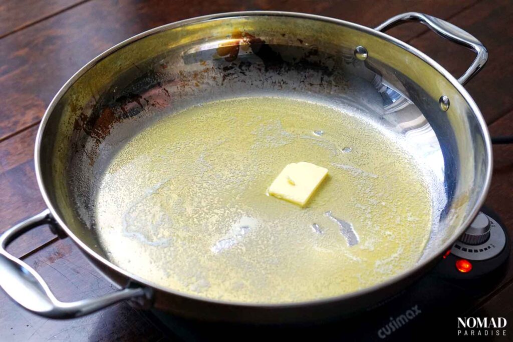 Adding the butter to the pan.
