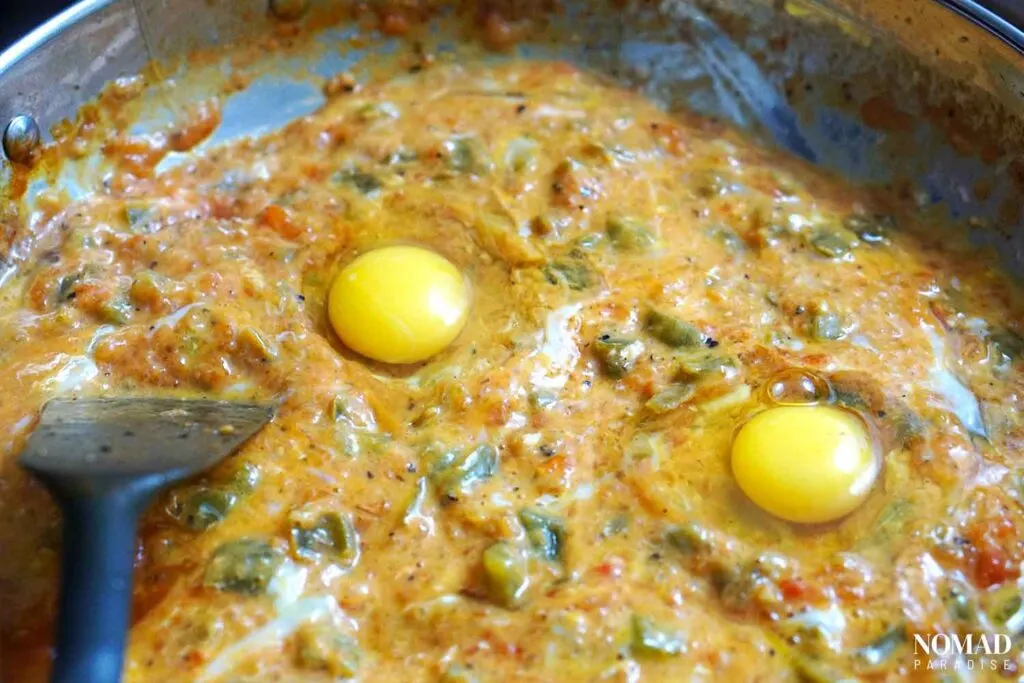 Adding and breaking the eggs in the menemen.