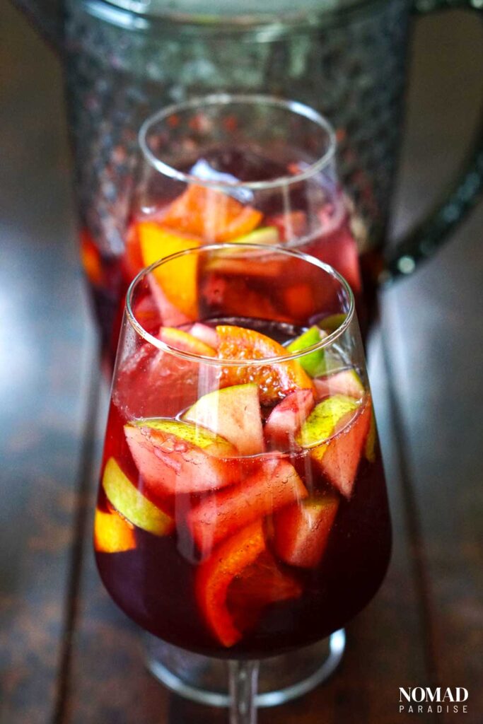 Two glasses and a pitcher of red wine sangria