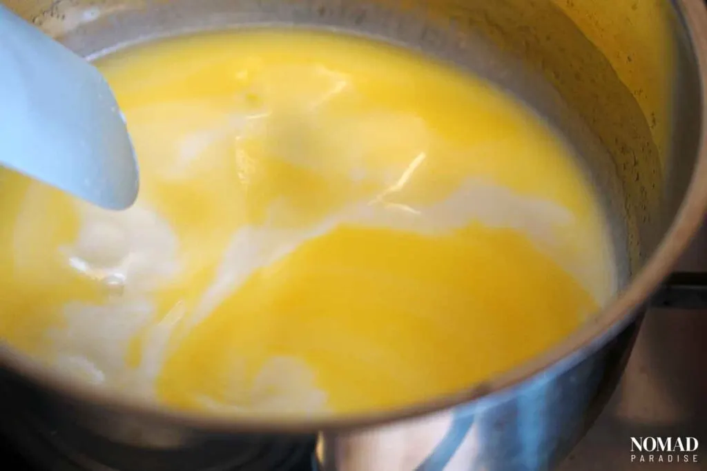 Melting butter and warming up milk in a small pot on the stove.