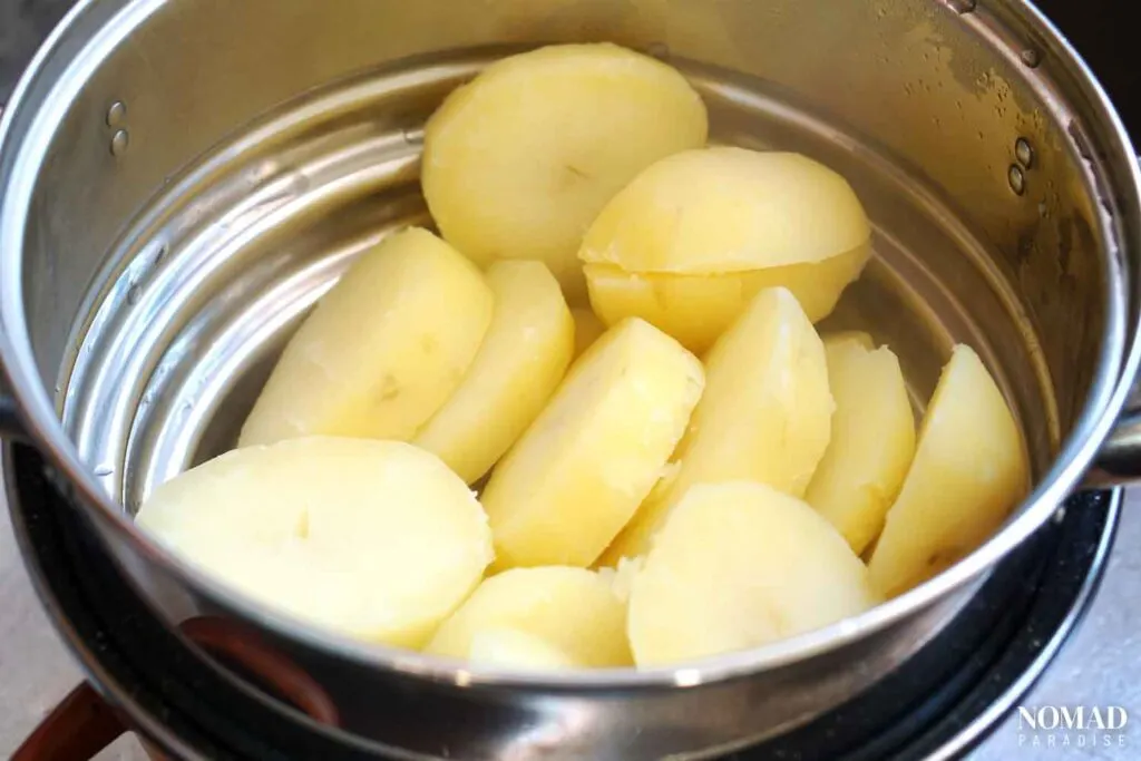 Draining the boiled potatoes.